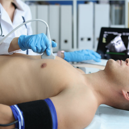 Doctor placing ultrasound probe on chest of male patient